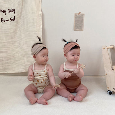 Babies wearing bodysuit with matching headband