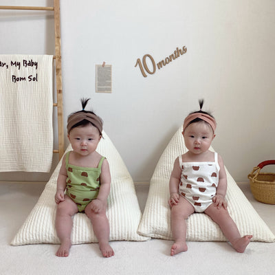 Babies wearing sleeveless onesie with bear prints