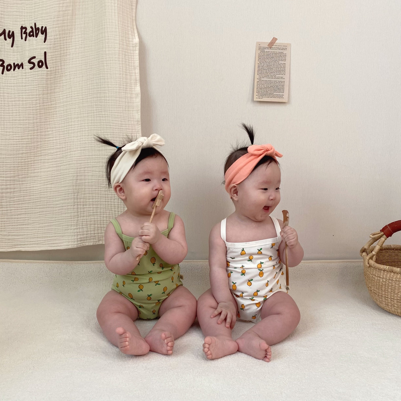 Babies wearing onesie in lemon prints