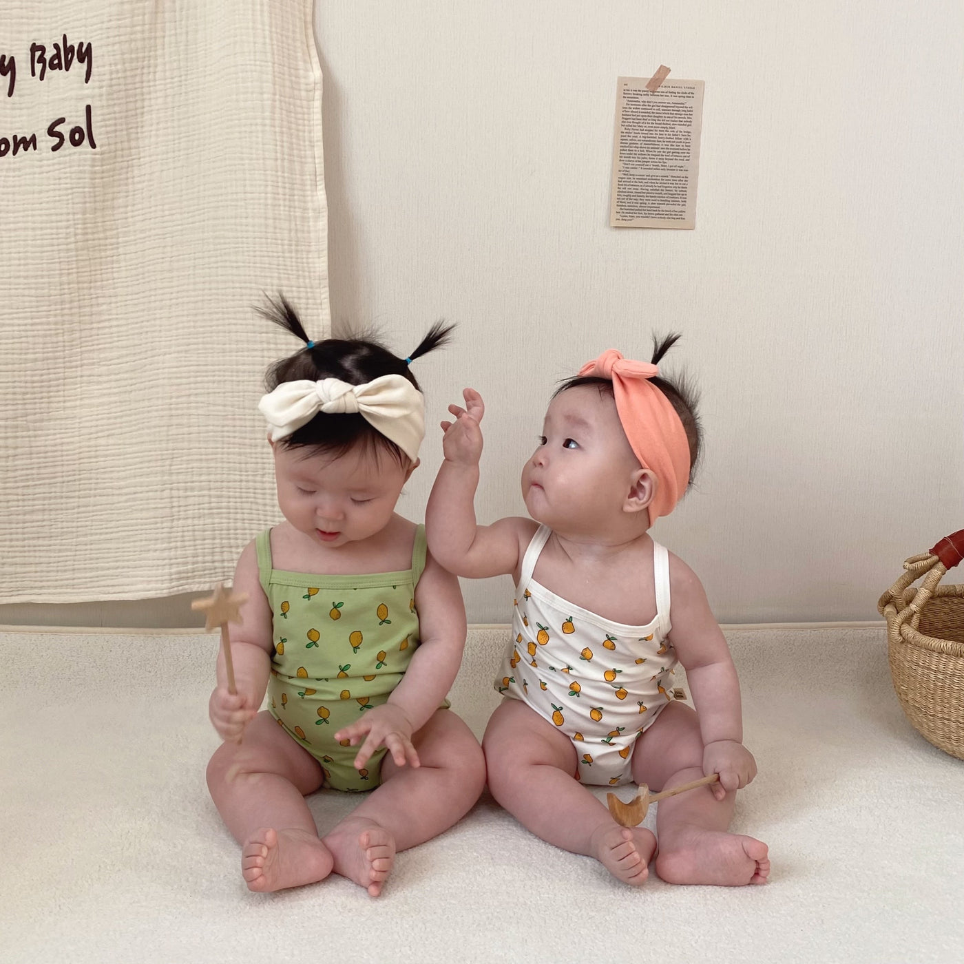 Babies wearing girl onesie in lemon prints