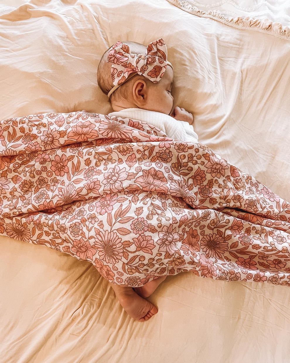 newborn muslin pink floral swaddle and matching bow headband